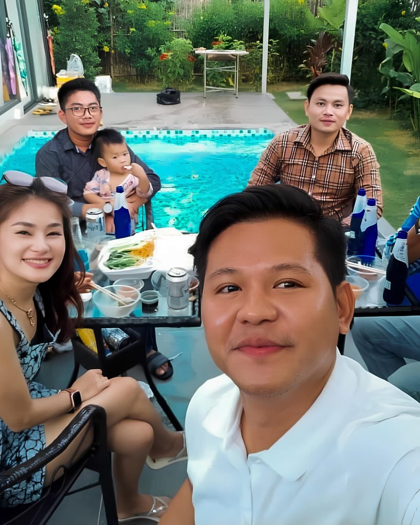 Family sitting at pool at damnak borey resort in kampot
