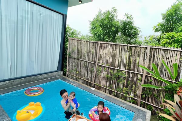 Family is chilling in private pool at boutique villa at damnak borey resort